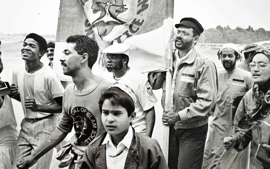 Call of Islam activists marching with a banner at a rally in the 1980s